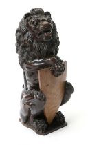 A Carved Oak Heraldic Lion, 18th century, possibly a newal post finial, modelled holding a vacant