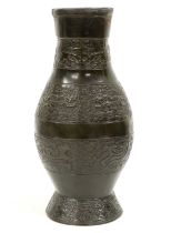 A Chinese Bronze Vase, in Archaic style, of baluster form cast with bands of mythical beasts on a
