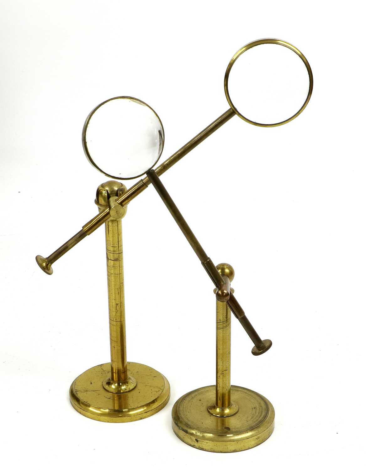 A Victorian Brass Bull's Eye Desk Magnifying Glass, of cantilever form wth gimbal hinge and circular