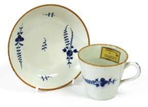 A Worcester Porcelain Coffee Cup and Saucer, circa 1770, of bucket shape, painted in underglaze blue