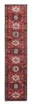 Narrow Heriz Runner North West Iran, circa 1970 The claret field with a column of medallions