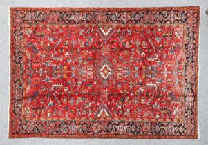 Heriz Carpet North West Iran, circa 1950 The raspberry field of serrated leaves and angular vines