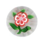A Baccarat Primrose Miniature Paperweight, circa 1850, worked with a single flower on a leafy