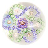 A Baccarat Garlanded Paperweight, circa 1850, the central canes within blue and green trefoil