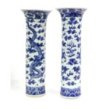 A Pair of Chinese Porcelain Sleeve Vases, 19th century, painted in underglaze blue, each with a pair