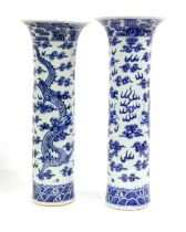 A Pair of Chinese Porcelain Sleeve Vases, 19th century, painted in underglaze blue, each with a pair