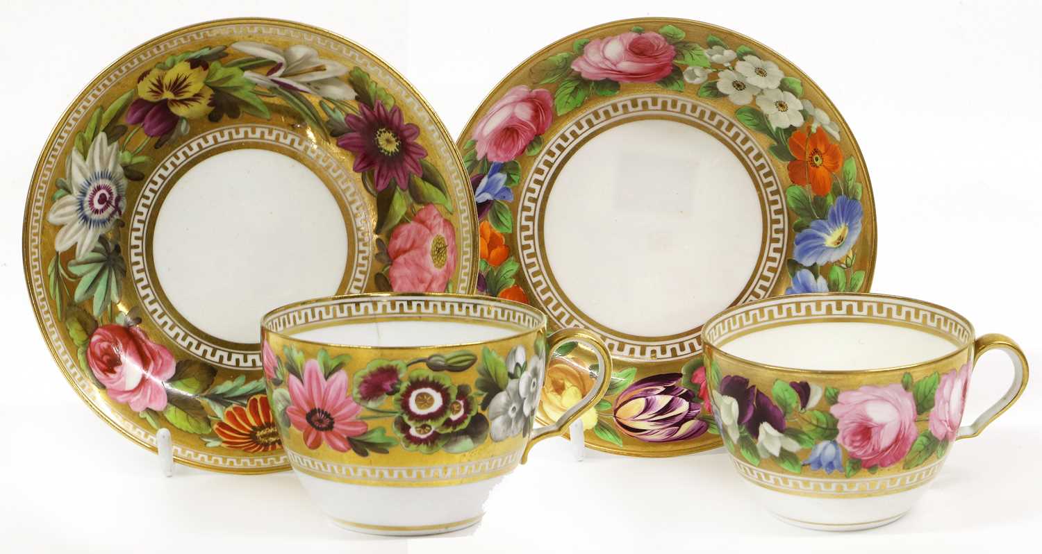 A Spode Teacup and Saucer, circa 1810, of bute shape, gilt ground and painted with large flowers