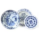 An English Delft Charger, circa 1770, painted in blue with a peacock stood on a riverbank by a