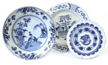 An English Delft Charger, circa 1770, painted in blue with a peacock stood on a riverbank by a