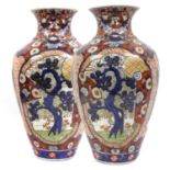 A Pair of Imari Porcelain Vases, Meiji period, of ovoid form and painted with panels containing pine
