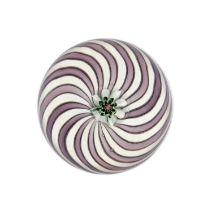 A Clichy Swirl Paperweight, circa 1850, with a central pink and green cane on an alternating