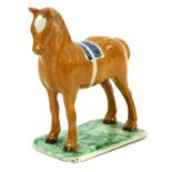 A Pearlware Model of a Horse, circa 1800-10, probably Newcastle, standing four square on a thin