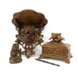 A Black Forest Carved Oak Wall Bracket, late 19th/20th century, the lobed demi-lune plinth over