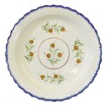 A Pearlware Charger, circa 1800, with feather moulded rim edged in blue, painted to the well with