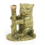 A Victorian Brass Novelty Inkwell, in a form of a seated bear with glass eyes, the hinged head