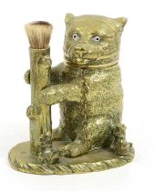 A Victorian Brass Novelty Inkwell, in a form of a seated bear with glass eyes, the hinged head