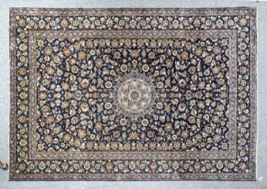 Isfahan Carpet Central Iran, circa 1970 The deep indigo field of palmettes and vines around a