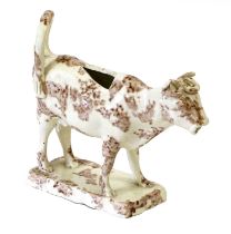 A Creamware Cow Creamer, circa 1770, with sponged brown glazes and on fluted rectangular plinth 13cm