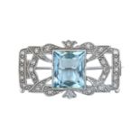 An Aquamarine and Diamond Brooch the fancy cut aquamarine in a white rubbed over setting, to a