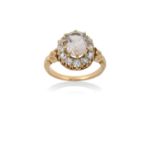 A Topaz and Diamond Ring the oval cut light pink topaz within a border of old cut diamonds, in