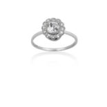 A Diamond Cluster Ring the old cut diamond within a border of eight-cut diamonds, in white