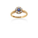 An 18 Carat Gold Sapphire and Diamond Cluster Ring the round cut sapphire within a border of old cut