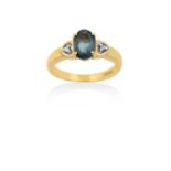 An 18 Carat Gold Alexandrite and Diamond Ring the oval cut alexandrite in a yellow four claw