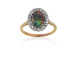An Opal and Diamond Cluster Ring the oval cabochon black opal within a border of old cut diamonds,