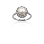 A Pearl and Diamond Cluster Ring the button pearl within a border of old cut diamonds, in white