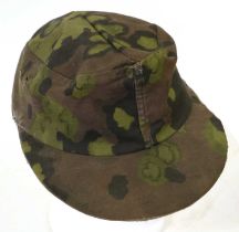 A Second World War German SS Field Cap, in reversible camouflage, each side with two ventilation