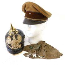 A First World War Prussian EM'S Pickelhaube, of black leather with brass conical spike, bullet
