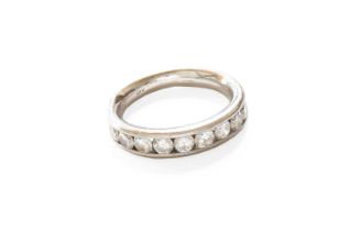 A Platinum Diamond Half Hoop Ring, nine round brilliant cut diamonds in a channel setting, to a