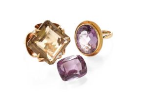 A 9 Carat Gold Amethyst Ring, the oval cut amethyst in a yellow rubbed over setting, to a tapered