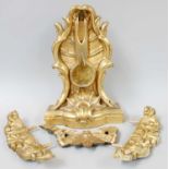 A Giltwood and Gesso Pocket Watch Stand, 19th century, ornamented with scrollwork and on bow front