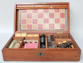 A Mahogany Games Compendium, 19th century, comprising dominoes, draughts, card games, various bone