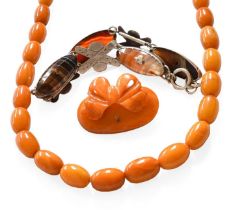 A Graduated Amber Bead Necklace, length 67cm; An Amber Brooch, length 4.3cm by 3.2cm (a.f.); and