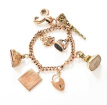 A Curb Link Bracelet, stamped '9C', suspending six charms including seals, a locket, etc., length