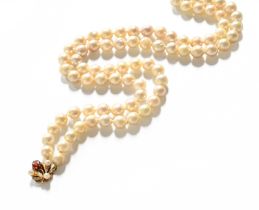 A Double Row Cultured Pearl Necklace, with a 9 carat gold garnet and cultured pearl clasp, length