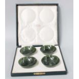 A Cased Set of Four Chinese Spinach Jade Bowls, of plain turned form, each 7cm diameter