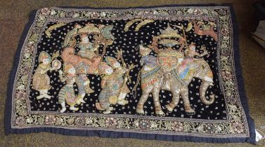 An Indian Stump Work Wall Hanging, decorated with a procession of figures, including an Elephant