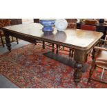 A Victorian Oak Wind Out Dining Table, with gadrooned molded top and on acanthus carved baluster