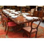 A Reproduction Cross-Banded Mahogany Twin Pillar Dining Table, with three additional leaves, 322cm