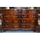 A Reproduction Mahogany Serpentine Chest, of two banks of four graduated short drawers, on bracket