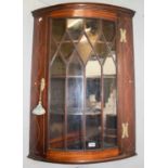 A George III Inlaid Mahogany Hanging Corner Cupboard, with strung inlay and glazed door, 69cm by