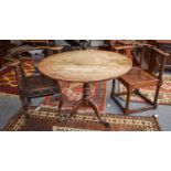 A George III Oak Tripod Table, 96cm by 73cm, together with two Victorian carved oak corner chairs (