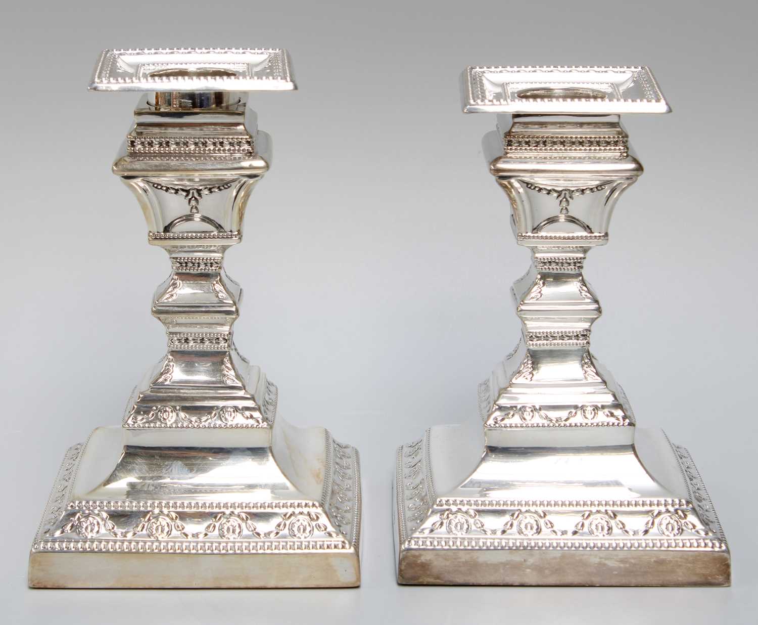 A Pair of Victorian Silver Candlesticks, by Henry Wilkinson and Co., London, 1891, on square base