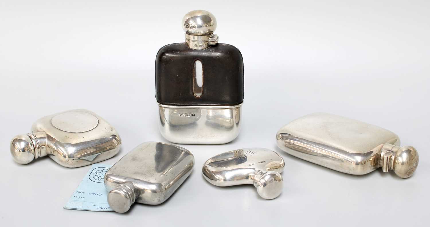 A Collection of Four Various Silver or Silver-Mounted Spirit-Flasks, variously shaped, one leather-