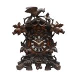 A Black Forest Striking Cuckoo Table Clock, circa 1890, carved to crest surmounted by a bird, case