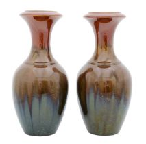 A Pair of Linthorpe Pottery Vases, shape No.887, in tones of green, brown, and white, impressed