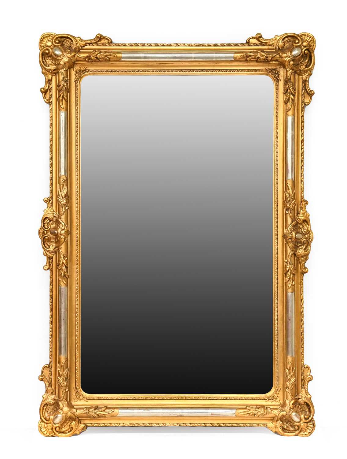 A Late 19th Century Gilt and Gesso Wall Mirror, the plain mirror plate surmounted with C scrolls and